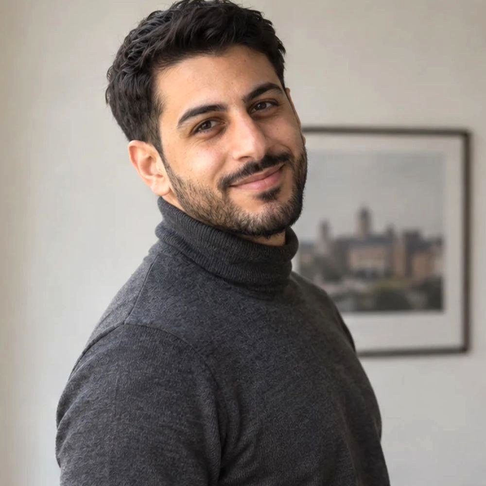 Smiling man in a charcoal turtleneck
